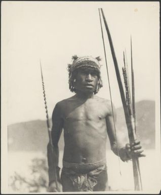 Ramu River man holding a bow and barbed arrows, Ramu River, New Guinea, 1935 / Sarah Chinnery
