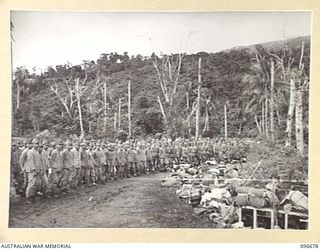 KAIRIRU ISLAND, NEW GUINEA. 1945-09-17. SOME OF THE 700 JAPANESE NAVAL FORCES ASSEMBLED WITH ALL THEIR GEAR AT THE BEACH HEAD ON THE ISLAND WAITING TO BOARD BARGES FOR TRANSFER TO MUSCHU ISLAND. ..