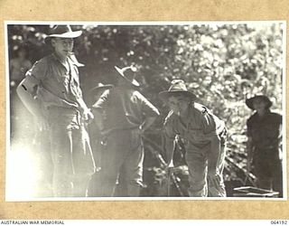 CANNING SADDLE, NEW GUINEA. 1944-01-20. MEMBERS OF THE COOKING STAFF OF THE 2/12TH INFANTRY BATTALION AT CANNING'S SADDLE PREPARING A MEAL FOR THE TROOPS PRIOR TO THEIR ATTACK ON THE ENEMY ..