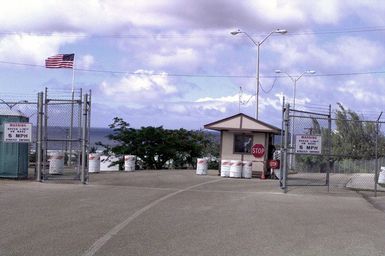 Shown is the front gate of the housing area in Tiyan, Guam, operated and maintained by US Marine Forces during PACIFIC HAVEN. PACIFIC HAVEN provided Kurdish evacuees political asylum from Iraq. While on Guam, the Kurds are provided shelter, food, clothing, medical care and assimilation classes for life in the United States