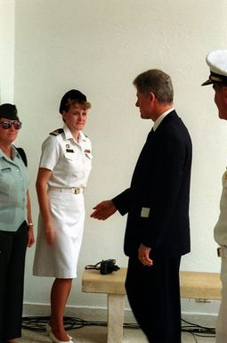 President William Jefferson Clinton greets a Navy officer upon his arrival at the ARIZONA (BB-39) Memorial. Clinton is in Hawaii to tour area military installations