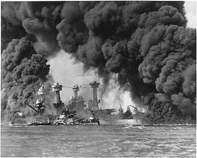 Naval photograph documenting the Japanese attack on Pearl Harbor, Hawaii which initiated US participation in World War II. Navy's caption: Battleships USS WEST VIRGINIA and USS TENNESSEE after the Japanese attack on Pearl Harbor on Dec. 7, 1941