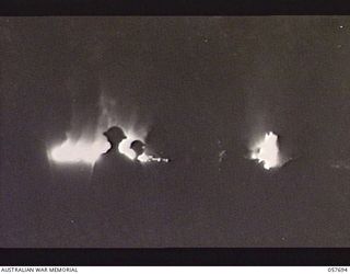 DOBODURA, NEW GUINEA. 1943-10-09. OIL DUMP BLAZING FURIOUSLY IMMEDIATELY AFTER THE JAPANESE AIR RAID ON THE AREA