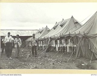 LAE, NEW GUINEA, 1944-03-25. PATIENTS EXERCISING OUTSIDE WARD NO. 17, 2/7TH GENERAL HOSPITAL. THE WARD CONTAINS SIXTY FOUR BEDS