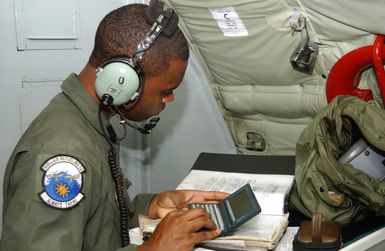 US Air Force (USAF) AIRMAN First Class (A1C) Corvus Lowery, Boom Operator, 909th Air Refueling Squadron (ARS), Kadena Air Base (AB), Okinawa, calculates weight and balance for his KC-135 Stratotanker. The aircraft is on station participating in the Joint Exercise TANDEM THRUST 03, a joint exercise conducted in the Marianas Islands to include Guam and Tinian. The exercise is a joint endeavor to include forces from the US, Canada, and Australia