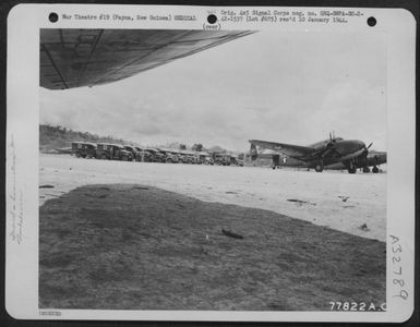 American and Australian ambulances lined up at Ward's Air Drome near Port Moresby, Papua, New Guinea, awaiting the arrival of ambulance planes from the front. 4 December 1942. (U.S. Air Force Number 77822AC)