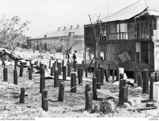 PORT MORESBY, PAPUA. 1942-07. DAMAGED BUILDINGS IN PORT MORESBY TOWNSHIP AFTER A JAPANESE AIR-RAID