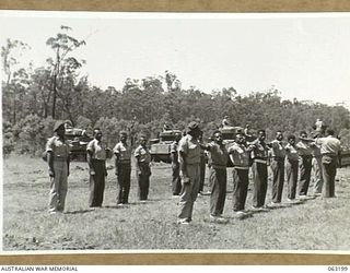 SOUTHPORT, QLD. 1944-01-18. A NATIVE SERGEANT MAJOR-IN-CHARGE NEW GUINEA POLICE BOYS CHECKING THE SQUAD PRIOR TO AN INSPECTION BY NX135 BRIGADIER D. MACARTHUR-ONSLOW, DSO., COMMANDING 4TH ARMOURED ..