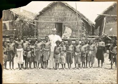 [Evan R. Stanley with unidentified village children, New Guinea]