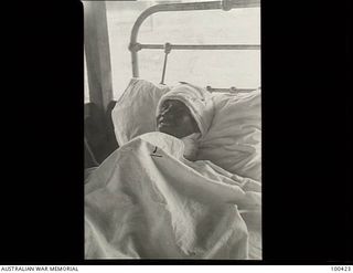 Port Moresby, New Guinea. 1944-05-09. Kararo, a young Javanese boy, rescued from the Japanese when the United States Marine Corps captured Karako near Hollandia on 1944-04-22, lies in bed at the ..