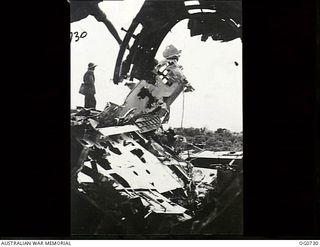 LAE, NEW GUINEA. C. 1944-02. JAPANESE AIRCRAFT THAT WERE ON THE AIRSTRIP AT LAE AND WERE STRAFED BY RAAF BOSTON AND BEAUFIGHTER AIRCRAFT HAVE NOW BEEN PUSHED TO ONE SIDE AND THE AIRFIELD IS USED BY ..