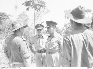 BLANCHE BAY, NEW BRITAIN. 1945-09-28. LIEUTENANT GENERAL J. NORTHCOTT, CHIEF OF GENERAL STAFF (3) CONFERS WITH MAJOR L.F. DARLING, PERMANENT PRESIDNET COURTS MARTIAL 11 DIVISION (1), WHO IS IN ..