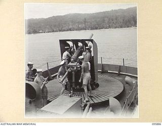 WEWAK HARBOUR, NEW GUINEA. 1945-09-03. THE GUN CREW OF THE TROOPSHIP SS RIVER FITZROY MANNING THE 4-INCH HIGH-ANGLE GUN WHICH HAS A RANGE OF 8,000 YARDS. THIS IS THE FIRST TIME AN AUSTRALIAN ..