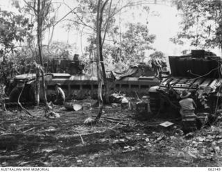 SCARLET BEACH AREA, NEW GUINEA. 1943-12-21. SX28156 CRAFTSMAN A. M. CROXTON (1) AND SX23601 CRAFTSMAN H. T. WILKINS (2) OF THE 1ST AUSTRALIAN TANK BATTALION GROUP WORKSHOP, AUSTRALIAN ELECTRICAL ..