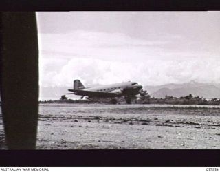 LAE, NEW GUINEA. 1943-10-11. DOUGLAS TRANSPORT AIRCRAFT LANDING ON THE AIRSTRIP