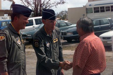 Major General Dalleger, 13th Air Force Commander, greets Carl Gutierrez, governor of Guam, upon his arrival to Andersen South Air Force Base. Gutierrez toured dormitories that are being converted into temporary housing for typhoon victims after Super Typhoon Paka destroyed many of their homes