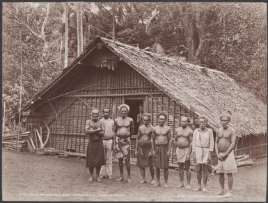 Old men of Heuru standing in front of a village building, Solomon Islands, 1906 / J.W. Beattie