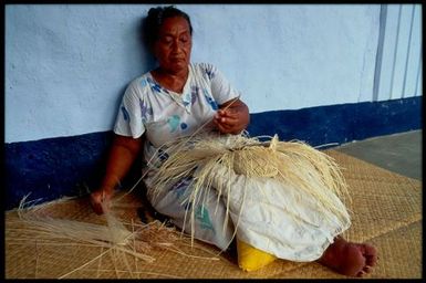 Woman weaving a rito hat, Cook Islands