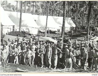 PALMALMAL PLANTATION, NEW BRITAIN. 1945-01-22. TROOPS BUILDING THE 2/8TH AUSTRALIAN GENERAL HOSPITAL PAUSE IN THEIR WORK TO ENJOY A CUP OF MORNING TEA SERVED BY THE YOUNG MEN'S CHRISTIAN ..