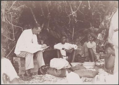Dr. Welchman distributing teachers pay at Maewo, New Hebrides, 1906 / J.W. Beattie