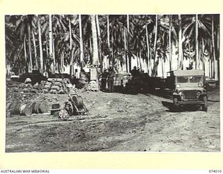 MILILAT, NEW GUINEA. 1944-06-19. PERSONNEL OF HEADQUARTERS COMMAND, 5TH DIVISION, AUSTRALIAN ARMY SERVICE CORPS, SORTING OUT RATIONS JUST LANDED ON THE BEACH AT DIVISIONAL HEADQUARTERS
