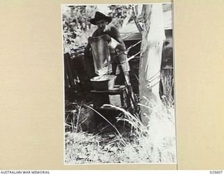 PORT MORESBY, PAPUA. 1942-07. HOME DUTIES. DOMESTICATED AUSTRALIAN TROOPS IN NEW GUINEA ARE EXPERTS NOW AT WASHING THEIR CLOTHES, AS THIS PICTURE SHOWS