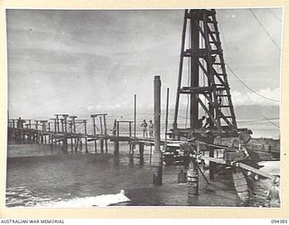 LAE AREA, NEW GUINEA. 1945-07-12. THE TANKER JETTY OF 2 BULK PETROLEUM STORAGE COMPANY. THIS COMPANY IS RESPONSIBLE FOR THE STORING AND DISTRIBUTION OF PETROL, OIL AND LUBRICANTS LANDED FROM ..