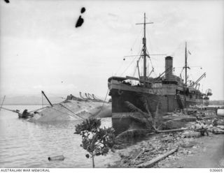 THE STEAMER ANSHUN LYING ON HER SIDE IN MILNE BAY, WHERE SHE WAS SHELLED AND SUNK BY A JAPANESE CRUISER. THE ANSHUN WAS LATER SALVAGED AND TOWED TO SYDNEY, A DISTANCE OF 1750 MILES