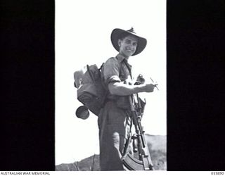 WAU AREA, NEW GUINEA. 1943-08-16. NX91691 PRIVATE N. G. DAVIS OF "D" COMPANY, 2/5TH BATTALION, CASTING HIS VOTE IN THE FEDERAL ELECTION BEFORE MOVING UP TO THE FRONT LINE