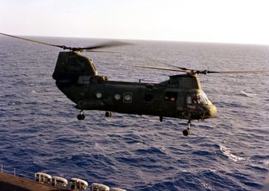 A CH-46E Sea Knight helicopter lifts off from the flight deck of the amphibious assault USS GUAM (LPH-9) during flight operations off the coast of Beirut. The ship is providing support to U.S. Marines deployed in Lebanon as part of a multi-national peacekeeping force following confrontation between Israeli forces and the Palestine Liberation Organization