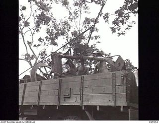 PORT MORESBY, NEW GUINEA. 1943-11-15. A "NORMAL" 25-POUNDER GUN OF THE 2/5TH AUSTRALIAN FIELD REGIMENT AFTER BEING STRIPPED DOWN TO ITS COMPONENT PARTS IS PACKED INTO A THREE TON TRUCK FOR DESPATCH ..