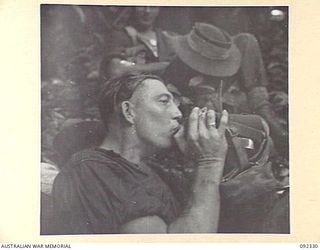 GAZELLE PENINSULA, NEW BRITAIN, 1945-05-10. A MEMBER OF 37/52 INFANTRY BATTALION TAKING A DRINK DURING THE TREK FROM RILE TO MAVELU, OPEN BAY