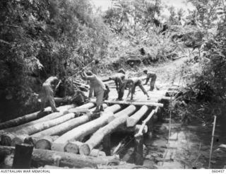 FINSCHHAFEN AREA, NEW GUINEA. 1943-11-09. ENGINEERS OF THE 870TH UNITED STATES ENGINEER AVIATION BATTALION, BUILDING A BRIDGE OVER A CREEK AT THE DREGER HARBOUR END OF THE NEW BOMBER AIRSTRIP