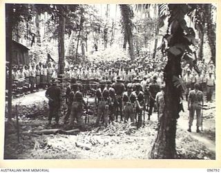 BONIS PENINSULA, BOUGAINVILLE, 1945-09-20. JAPANESE NAVAL TROOPS ON PARADE AT JAPANESE NAVAL HQ, BONIS PENINSULA. MAJOR H.ST.C. BROCKWAY, A MEMBER OF THE AUSTRALIAN SURRENDER PARTY FROM HQ 2 CORPS, ..