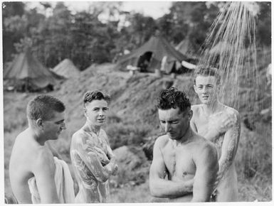 Members of the Royal New Zealand Air Force, in the Pacific Islands during World War II, showering outside