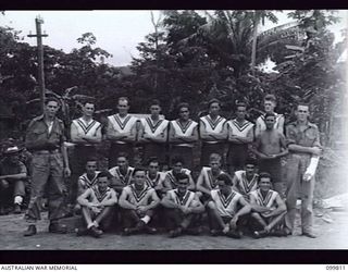 RABAUL, NEW BRITAIN, 1946-02-06. THE COMPETITION WINNING FOOTBALL TEAM OF 29/46TH INFANTRY BATTALION. PHOTOGRAPH SHOWS FULL TEAM, INCLUDING THE CAPTAIN, PRIVATE CHRISTENSEN (RIGHT) WHO SUSTAINED AN ..