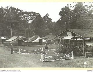 LAE BASE AREA, NEW GUINEA. 1944-12-29. A SECTION OF THE CAMP AREA OF THE 1 FORTRESS SIGNALS SECTION SHOWING THE "PALM LODGE CABARET" THE UNIT RECREATION HUT IN THE RIGHT FOREGROUND