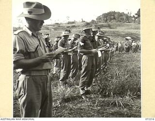 GUSIKA, NEW GUINEA. 1944-04-09. MEMBERS OF THE 2/4TH LIGHT ANTI-AIRCRAFT REGIMENT AT A MEMORIAL SERVICE HELD IN HONOUR OF MEMBERS WHO WERE KILLED IN ACTION IN THE FINSCHHAFEN - SCARLET BEACH AREA. ..