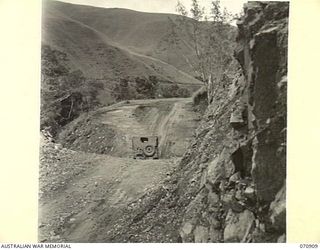 WAU - LAE ROAD, NEW GUINEA, 1944-02-26. A CULVERT THIRTY-ONE AND A HALF MILES FROM WAU THAT REPLACES A BRIDGE AT THIS POINT IN THE ROAD. THIS SECTION IS MAINTAINED BY THE 1ST MECHANICAL EQUIPMENT ..