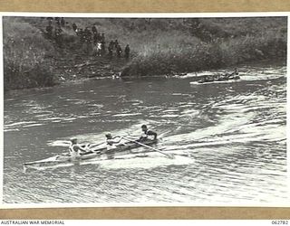 KUBA LAKE, RAMU VALLEY, NEW GUINEA. 1943-12-25. THE BOAT RACE IN PROGRESS AT THE CHRISTMAS CARNIVAL AND REGATTA ORGANISED BY MEMBERS OF THE 2/14TH INFANTRY BATTALION, 7TH DIVISION. SHOWN ARE: ..