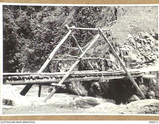 BULLDOG-WAU ROAD, NEW GUINEA. 1944-01-19. A SMALL TRESTLE BRIDGE CONSTRUCTED BY PERSONNEL OF THE 2/4TH AUSTRALIAN FIELD SQUADRON OVER THE ELOA RIVER AT THE 19 1/2 MILE