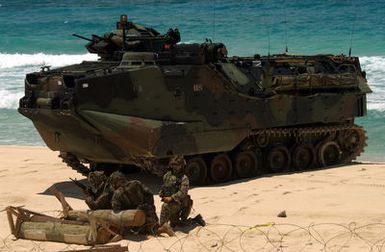 US Marine Corps (USMC) Marines, 3rd Battalion, 3rd Marine Regiment, guard their AAV7A1 Assault Amphibian Vehicles (AAV) following a mechanized raid in support of exercise Rim of the Pacific 2004 (RIMPAC 2004). RIMPAC is the largest international maritime exercise in the waters around the Hawaiian Islands. This year's exercise includes seven participating nations: Australia, Canada, Chile, Japan, South Korea, the United Kingdom and the United States. RIMPAC is intended to enhance the tactical proficiency of participating units in a wide array of combined operations at sea, while enhancing stability in the Pacific Rim region