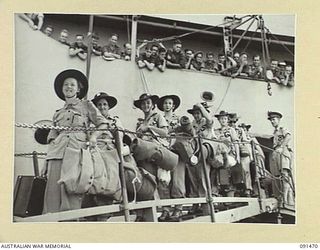 LAE, NEW GUINEA, 1945-05-07. AUSTRALIAN WOMEN'S ARMY SERVICE PERSONNEL MOVING DOWN THE GANGWAY TO THE WAITING LANDING BARGES DURING DISEMBARKATION FROM THE MV DUNTROON. THE DUNTROON CARRIED A GROUP ..