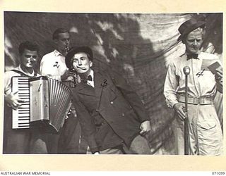 KILIGIA, NEW GUINEA. 1944-03-13. MEMBERS OF THE 3RD ARMOURED DIVISION CONCERT PARTY REHEARSING FOR "SHELLSAPOPPIN" A SHOW WELL KNOWN TO TROOPS IN NEW GUINEA. THE CONCERT PARTY IS AT PRESENT ..