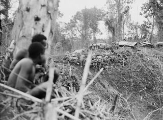 Bougainville, Solomon Islands. 1944-12-30. Troops of the Australian 2/25th Infantry Battalion taking cover on the rear slope of North-East Spur (Artillery Hill) when Japanese snipers opened up on ..