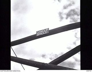 DONADABU, NEW GUINEA. 1943-11-03. SIGN ERECTED ON A BRIDGE SPANNING THE LALOKI RIVER BY SAPPERS OF THE 24TH AUSTRALIAN FIELD COMPANY, ROYAL AUSTRALIAN ENGINEERS. THE NAME "DAMOUR BRIDGE" NO DOUBT ..