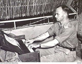 RABAUL, NEW BRITAIN, 1945-12-25. CAPTAIN W. L. MANN, GENERAL STAFF OFFICER 3 (OPERATIONS), HEADQUARTERS 11 DIVISION, PLAYING THE ORGAN DURING THE CHRISTMAS SERVICE AT ST ALBAN'S CHURCH OF ENGLAND