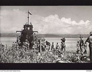 GILI GILI, NEW GUINEA, 1943-07-15. TROOPS OF THE 29TH AUSTRALIAN INFANTRY BRIGADE, 5TH AUSTRALIAN DIVISION, LOADING STORES BY "ROUND ROBIN" PRIOR TO EMBARKING ON AMERICAN LCI'S (LANDING CRAFT ..