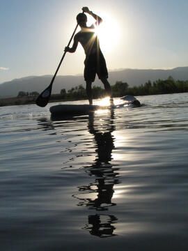 Paul Lugar, a personal trainer and cycling coach in Boulder, paddles his way across the Boulder Reservoir in the late afternoon. Lugar is riding Sevylor Sports' new "Samoa" - a new inflatable model of the stand-up paddle boards that are all the rage in Ca