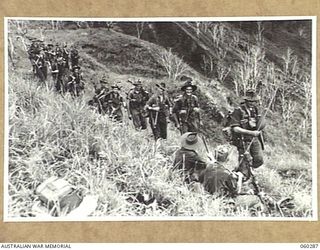 RAMU VALLEY AREA, NEW GUINEA, 1943-11-08. NO. 17 PLATOON, D COMPANY, 2/27TH AUSTRALIAN INFANTRY BATTALION MOVING ALONG THE TRACK FROM GUY'S POST. SHOWN ARE: SX18023 LANCE CORPORAL R. J. MANNING ..